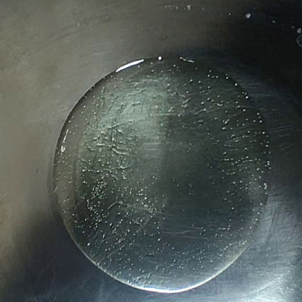 oil is poured in silver work to make beef mince