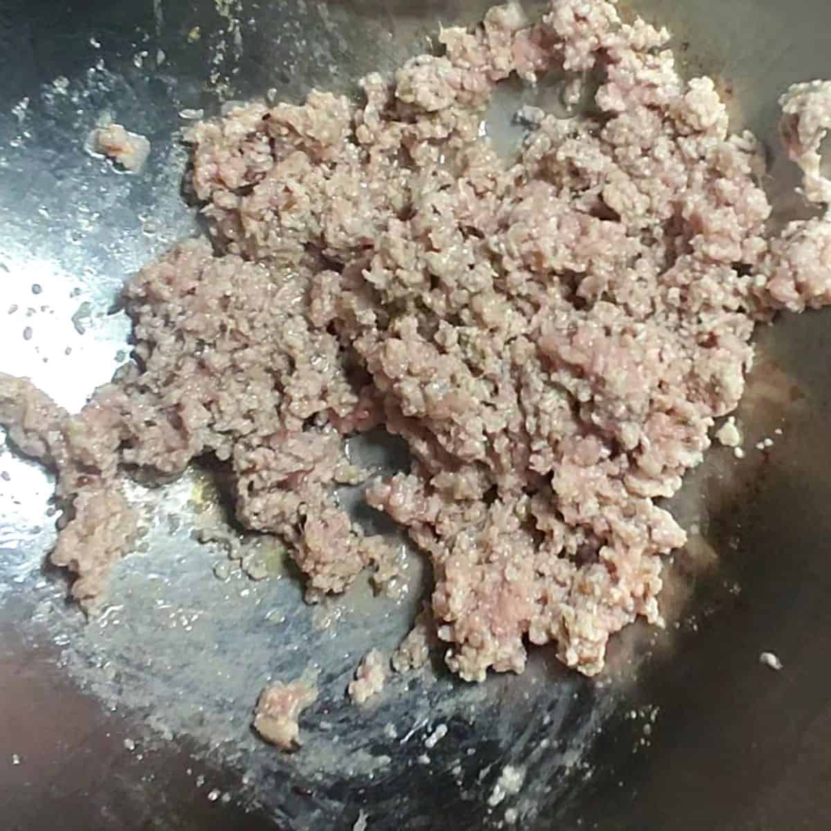 beef mince is added in silver wok