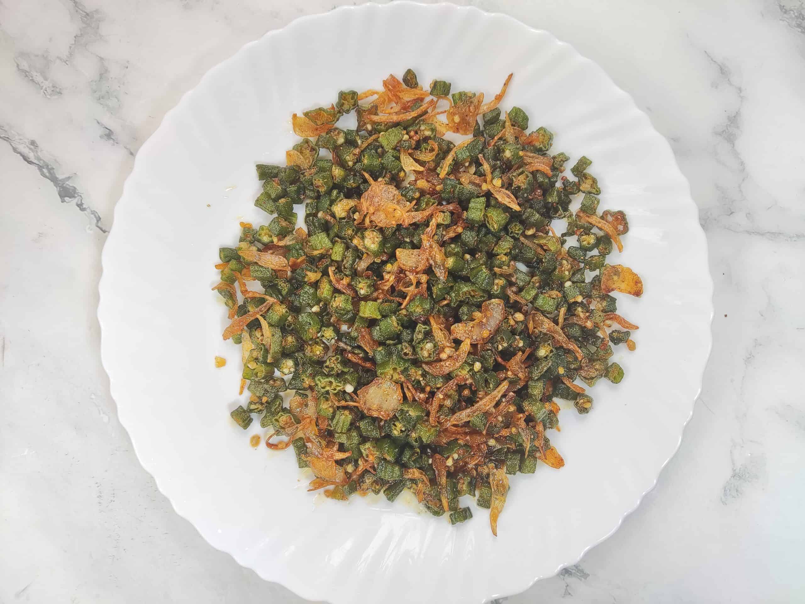 Crispy Bhindi fry served in a big white platter.