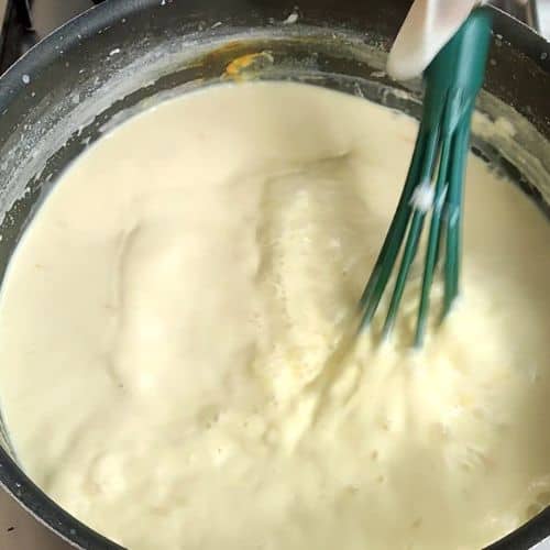 Boil the milk in a large pan till it thickens, about 30-40 minutes.