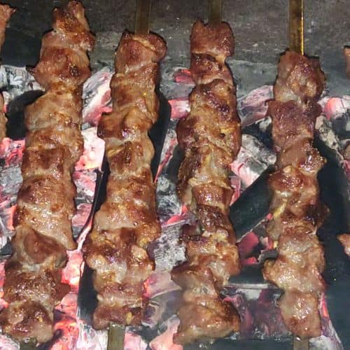 Grill the beef skewers until brown and charred.