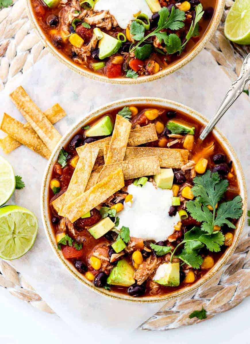 healthy slow cooker chicken tortilla soup brothy black beans corn lime cilantro crispy strips avocado freezer-friendly