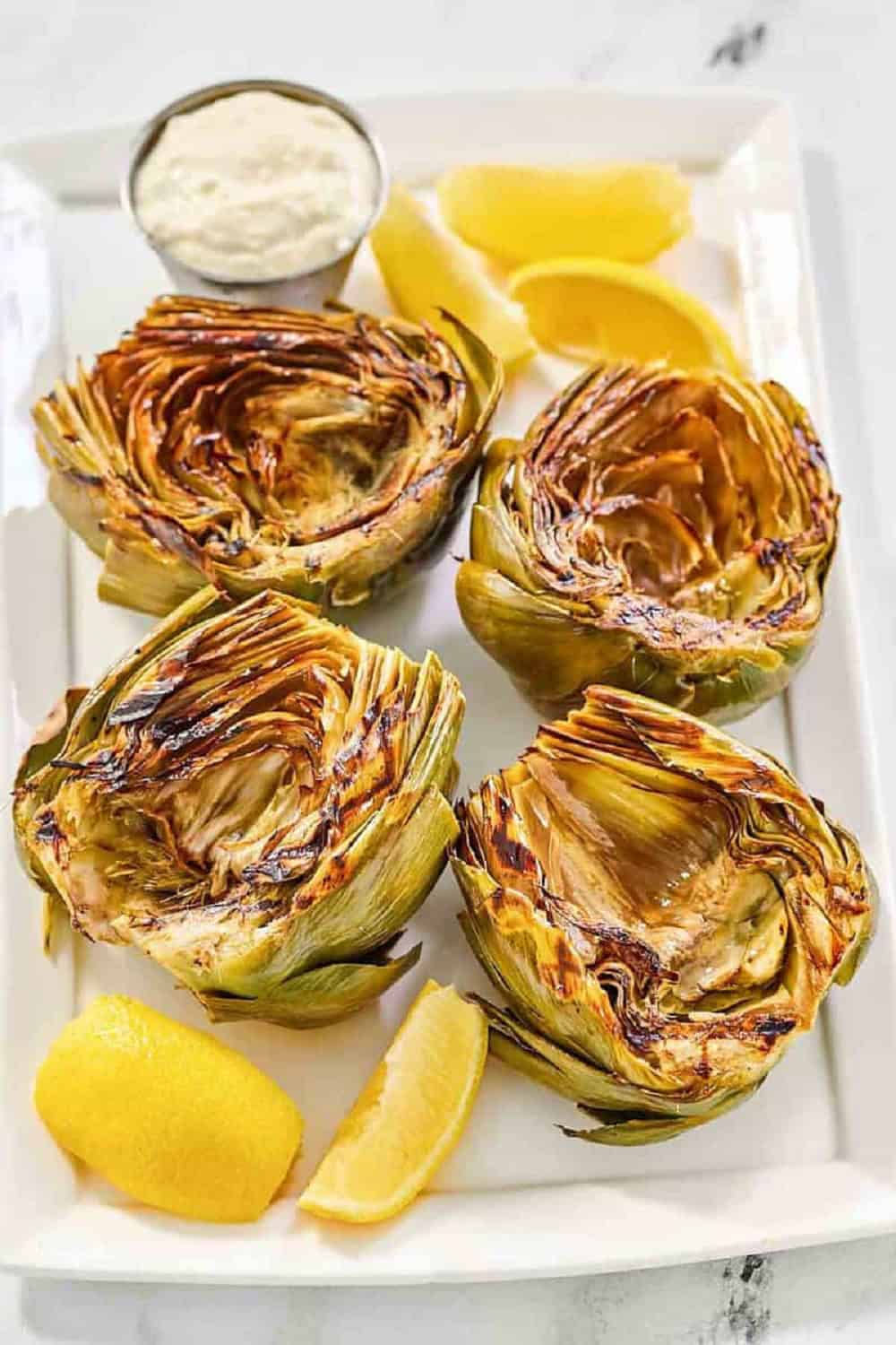 grilled artichokes garlic aioli charred crispy lemon dipping sauce elegant appetizer steamed Mediterranean restaurant-quality