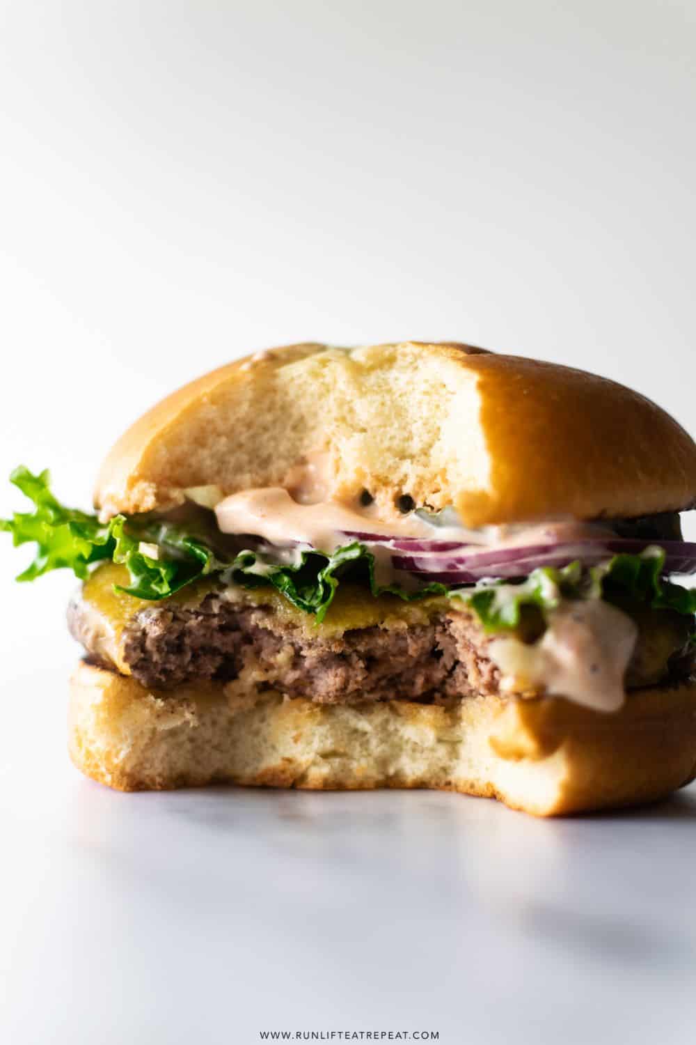 smash burger recipe ground beef crispy edges American cheese pickles classic American diner-style fast food