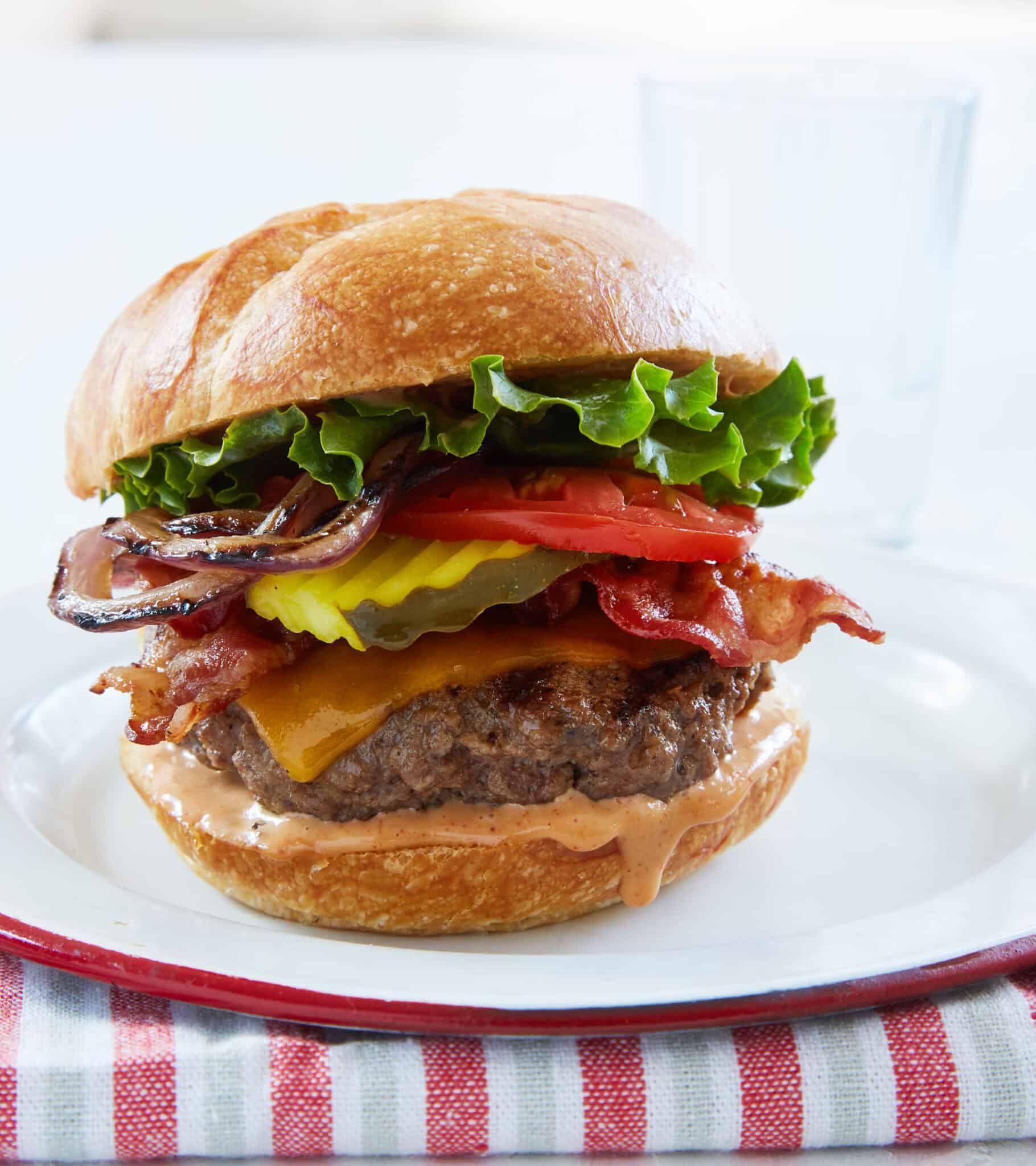 ultimate cheeseburger crispy bacon juicy beef patty grilled onions secret sauce melted cheddar brioche bun classic BBQ