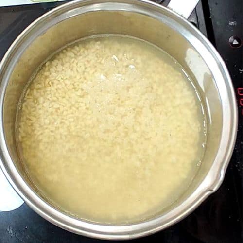Daal mash cooked in a stainless steel pot, showing creamy beige texture with soft consistency.