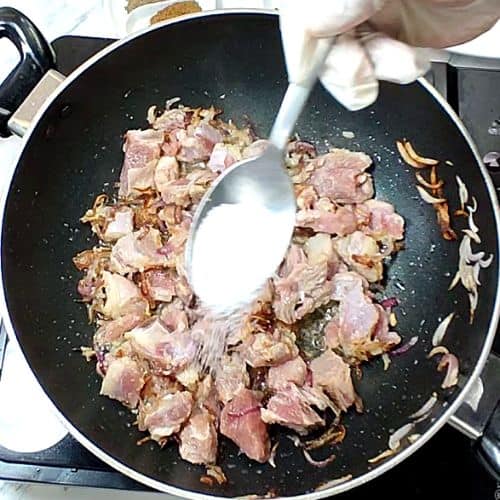 Salt added to lamb in pan