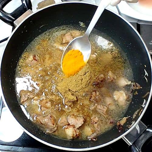 Turmeric powder added to the curry