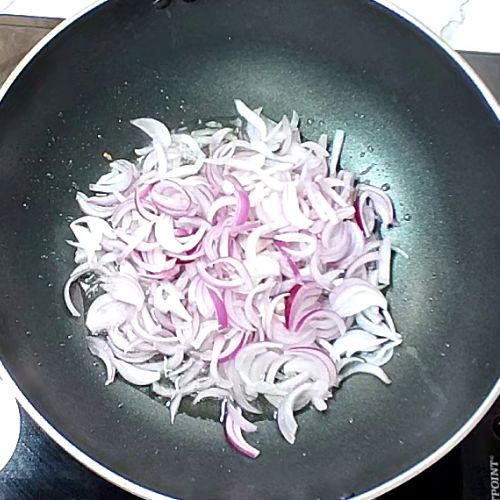 Sliced onions added to spiced oil