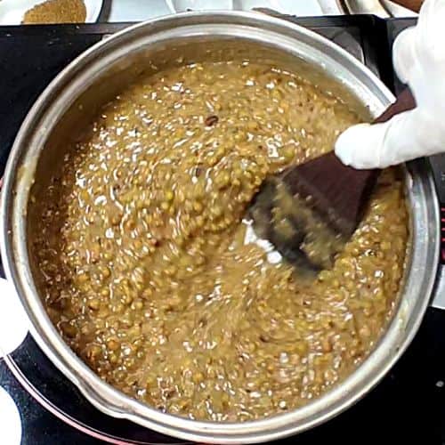 Tarka being poured over moong gosht