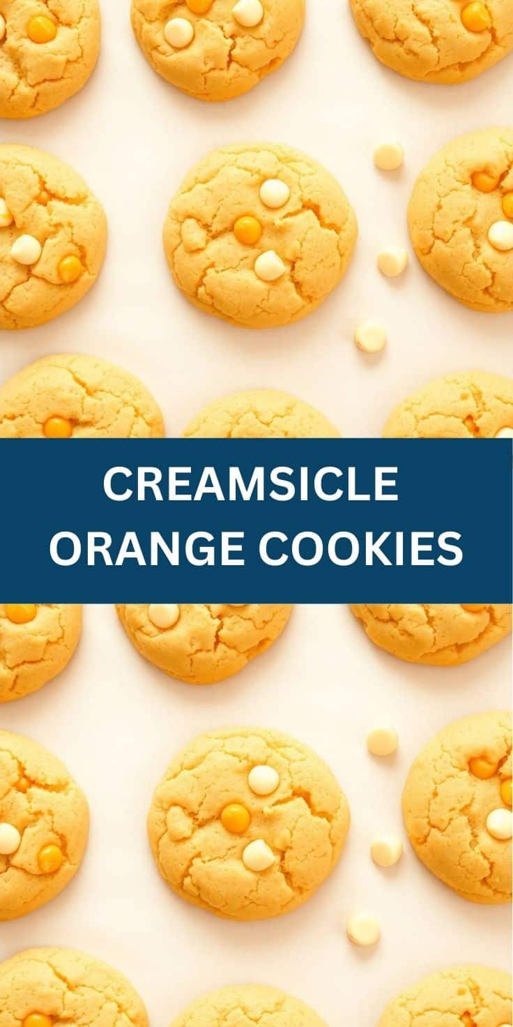 Creamsicle orange cookies with white and orange candy pieces arranged on white background.