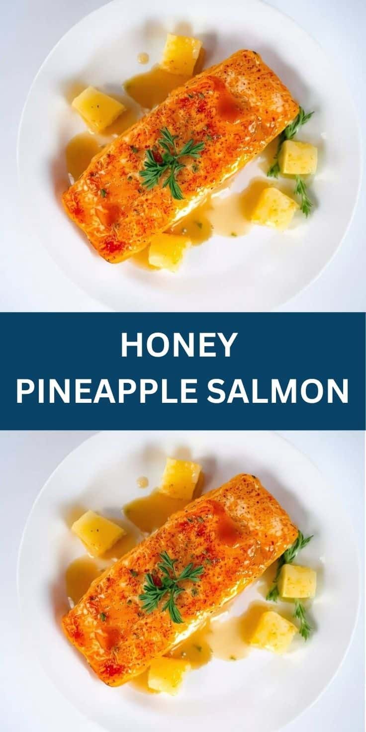 Honey pineapple salmon fillet with golden crust, fresh pineapple chunks, and parsley garnish on white plate.