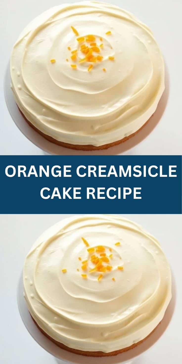 Orange Creamsicle cake with cream frosting swirl and candied orange peel garnish on white background.