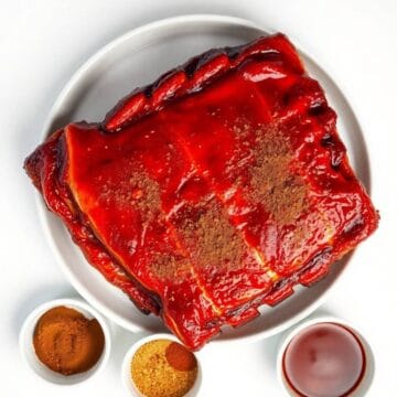 Delicious smoked baby back ribs glazed with rich barbecue sauce, served with spices and dipping sauc.