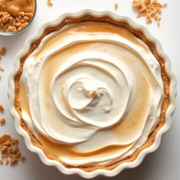 Delicious butterscotch Cool Whip pie with creamy topping in a decorative crust.