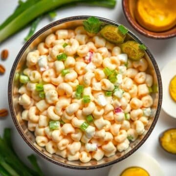 Creamy macaroni salad with fresh vegetables and herbs, perfect for picnics and gatherings.