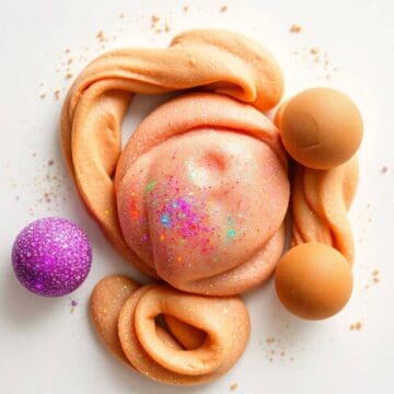 Colorful glittery playdough with foam balls and swirls for kids' craft activity.