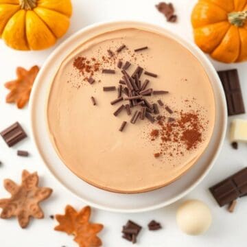 Delicious pumpkin chocolate mousse cake topped with chocolate shavings and spices. Perfect for fall.
