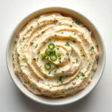 Delicious dill pickle dip garnished with chopped green onions.
