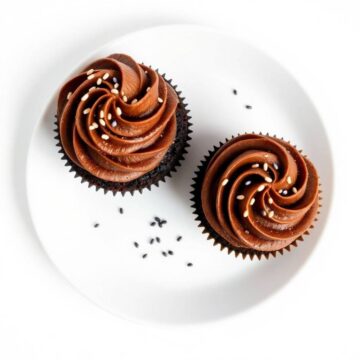 chocolate cupcakes for two with swirled frosting and sprinkles close up