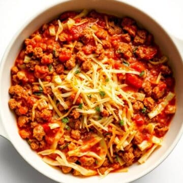 Delicious low carb unstuffed cabbage casserole with ground meat, tomatoes, and cheese.