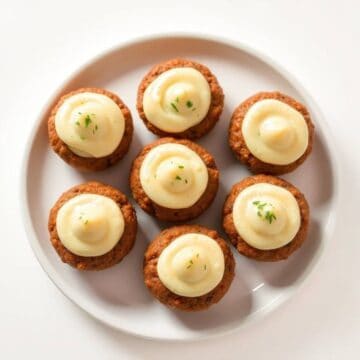 Delicious mini meatloaf muffins topped with creamy mashed potato frosting, perfect for appetizers or.