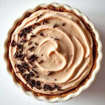 Mocha cream pie with chocolate shavings in a pie crust.
