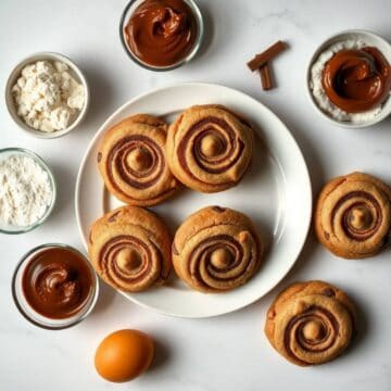 Delicious Nutella cookies with chocolate swirls and fillings on a white plate.