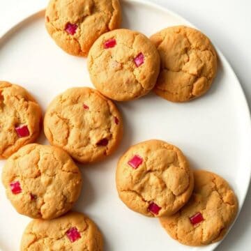Sweet rhubarb cookies with vibrant red pieces, perfect for dessert or snack. Freshly baked, golden,.