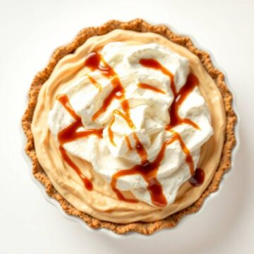Delicious root beer float pie topped with whipped cream and caramel drizzle.
