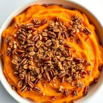 Delicious sweet potato casserole topped with pecans and crumble, perfect for holiday dinners.