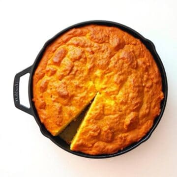 Golden skillet cornbread with crispy top, perfect for comfort food lovers.
