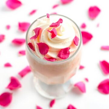 Creamy vanilla rose shake topped with rose petals, perfect for dessert lovers.
