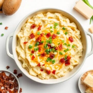 Delicious loaded mashed potato casserole topped with cheese, bacon, and green onions. Perfect comfor.