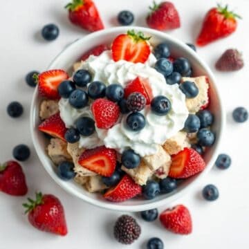 Cheesecake salad with fresh strawberries, blueberries, and whipped cream. Perfect patriotic dessert.